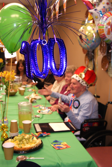 Photos by Karen ZautykAnthony Dusman, 100 years young, used not a knife, but a karate chop, to cuthis birthday cake, much to surprise and delight of his family (from l.) daughterDoris Russ, great-grandniece Rebecca, and daughter Helen Skibiak.
