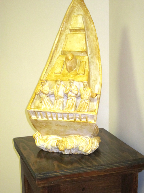 Photo by Ron LeirClay model of front of monument shows Four Chaplains praying.