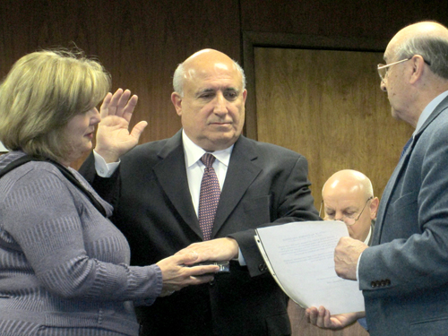 Photo by Ron LeirPeter Norcia (c.) is sworn in as North Arlington councilman by Mayor Peter Massa as Norcia’s wife Pat holds Bible.