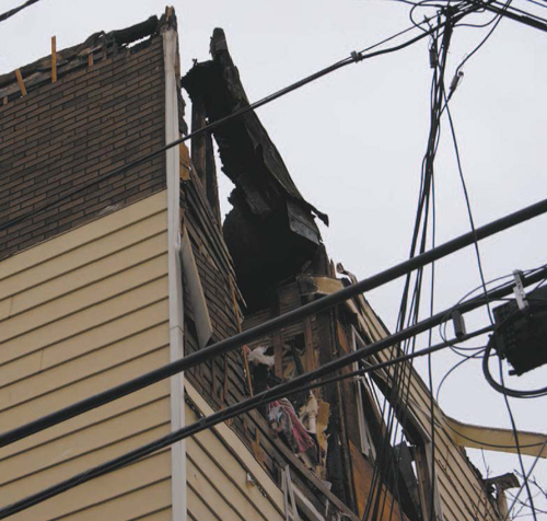 Photos by Karen ZautykSix-family home at corner of Devon and Hoyt Sts. was left roofless by Sundayfire.