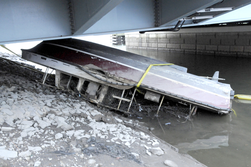 Photo courtesy Chris Brooks The upended Riverwatch boat, before its removal from under the Belleville Bridge.