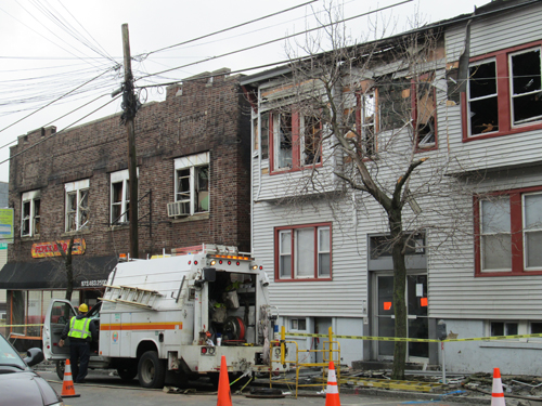 Photo by Ron Leir Utility crews arrive at fire scene Monday morning as prelude to demoltion.