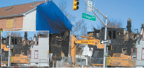 Photos by Ron Leir Demolition crew at work Monday finishing off cleanup at Rodgers Boulevard fire scene.