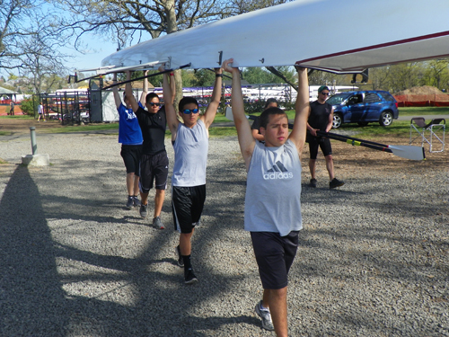 Photo by Al Perez The North Arlington novice 4 team, namely from back to front, Vinny Ribeiro, Bryan Ugaz, Nathaniel DeLeon and Jose Antunes, carry their boat toward the Passaic River for crew practice recently.