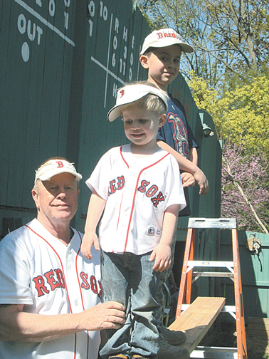Photo by Ron Leir Steven Turowski with grandchildren Jason, 4, (c.) and Stevie, 8, in front of the Nutley version of the Green Monster.