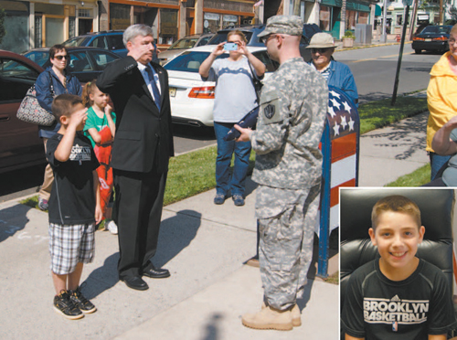 Photo by Karen Zautyk Public Affairs Commissioner Steven Rogers and Commissioner-for-a-Day Brian Conte (in inset) accept ‘retired’ flag.