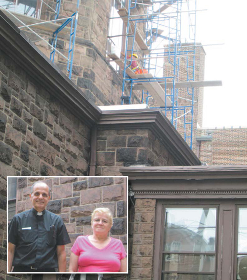 Photos by Ron Leir As the Rev. Joseph Girone, pastor of Holy Cross Church, and Maria Silva watch, workers proceed with window restoration at the church.