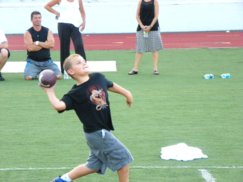 Photo by Jim Hague Seven-year-old Vincent Richard throws the football during the Kearny football camp.