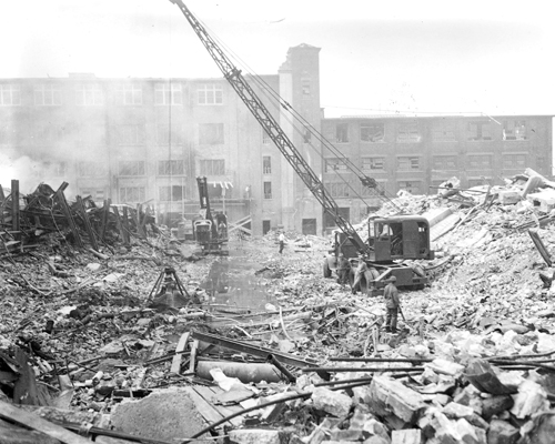 Photos courtesy KPD (Top) View of blast site as seen from Belgrove Drive vantage point. Large building on hill across river would in 1957 become Essex Catholic High School. (Bottom) Cranes and steam shovels begin clearing mountain of debris.