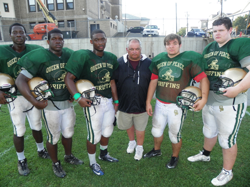 Photo by Jim Hague Queen of Peace’s football team has a lot of returning players, making new head coach Robert Kearns pleased. Kearns was a long-time assistant and former head coach of the Golden Griffins. From l. are Michael Akanbi, Babatunde Ojo, Shadaun Brown, Kearns, Andrew Gonzalez and Peter Lorfink.
