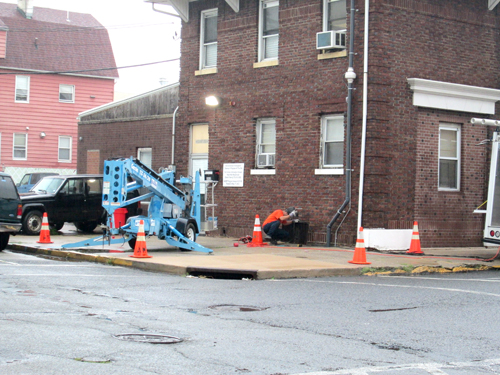 Photo by Ron Leir Worker installs indoor air mitigation system at Kearny First Aid Squad building last week.