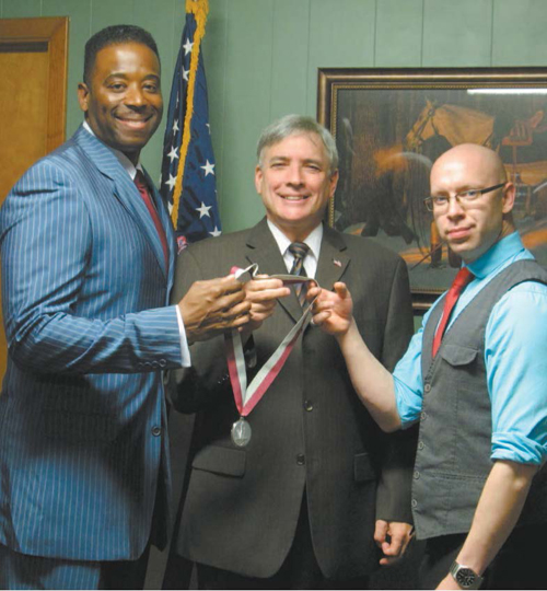 Photo by Ron Leir Commissioner Steven Rogers (c.), Courtney Johnson (l.) and Dan Jacoby display Nutley’s WWII veterans medal.