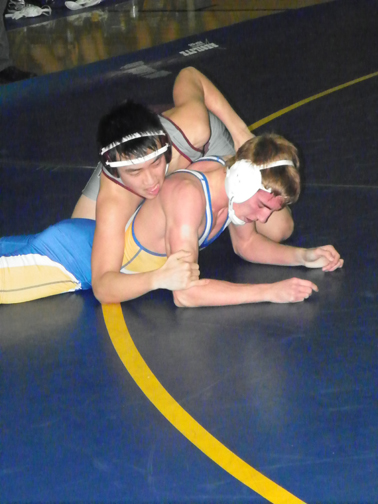 Photo by Jim Hague Lyndhurst/North Arlington sophomore Andrew Fernandez (bottom) got the chance to compete in his home gym Friday night, as the North Arlington student won his match against Patrick Yun of Leonia/Palisades Park, 18-8, helping Lyndhurst/North Arlington win the match, 46-27. It was the first match at North Arlington in five years