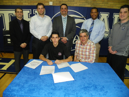 Photo by Jim Hague North Arlington senior Danny Cordeiro (seated l.), flanked by his dad, Carlos Cordeiro, signs his national letter of intent to attend the New Jersey Institute of Technology and play soccer at the Newark school in the fall. Standing, from l., are: Vice Principal Dennis Kenny, Head Soccer Coach Jesse Dombowski, Principal Lou Manuppelli, Athletic Director Dave Hutchinson and Track and Field Coach Joe Cioffi.