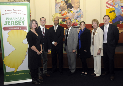 Photo courtesy David Mach At award ceremony, from l., are Jenny and David Mach; PSE&G Service Vice President Richard T. Thigpen, PSE&G Public Relations Director Art Gida, PSE&G Sustainability Manager Angela Ortiz, Sustainable Jersey Board Chair Pam Mount, and Sustainable Jersey Co-Director Randy Solomon.
