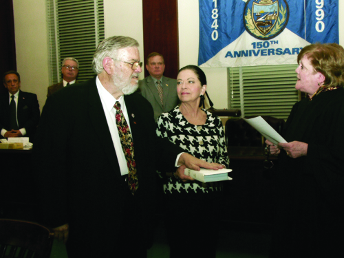 Photo courtesy Town of Harrison As his wife Linda holds the Bible, James Fife is sworn in as interim mayor by Municipal Court Judge Elizabeth McNamara.