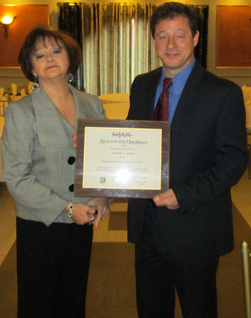 Photo courtesy Fernando Semiao Semiao accepts 2013 Realtor of the Year award from Meadowlands Board of Realtors President Nancy Lastra.