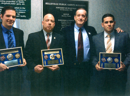 Photo courtesy Belleville PD Andy Kohut of AAY presents plaques to, from l. Dets. Matthew Dox, Joseph Mundy and Rafael Reyes.