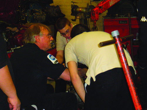 Top photo by Johnny B. Bucsko; bottom photo courtesy Debbie Kuhrt Above, Fred Kuhrt and his beloved 1969 MG; below, Kuhrt working with his automotive technology students.