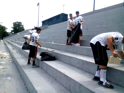 Photos courtesy Joe Fischer Belleville football players climb the stairs at Belleville Stadium to clean the facility after graduation ceremonies recently.