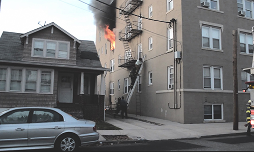 Photo Courtesy of Andy Taylor via Youtube. A resident is helped down on a ladder at a Beech St. fire Sunday afternoon. Photo Courtesy of Andy Taylor via Youtube. A resident is helped down on a ladder at a Beech St. fire Sunday afternoon.