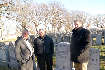 Photo by Karen Zautyk At Sunday’s ‘Rest in Peace’ service at gravesite in Holy Cross Cemetery (from l.): The Rev. Gary Grindeland, headstone hero Bruce Dillin, and John Burns of Hopper Monuments.