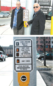 Photos by Ron Leir Lyndhurst Mayor Robert Giangeruso (r.) and consulting engineer Brian Intindola check out one of the pedestrian push-button crossing stations at Kingsland/Riverside Aves. intersection.
