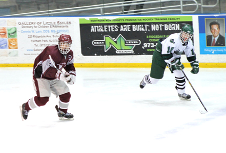 Photos by Renee Hoarle TOP: Nutley junior goalkeeper Joey Hoarle has been rock solid in goal for the Maroon Raiders, picking up a shutout in a 2-0 win over Livingston last Saturday night. BOTTOM: Nutley senior center Mike Frade (l.) skates up ice during Nutley’s 2-0 win over Livingston Saturday at the Codey Arena. Frade leads the Maroon Raiders in scoring with 23 goals and 13 assists.